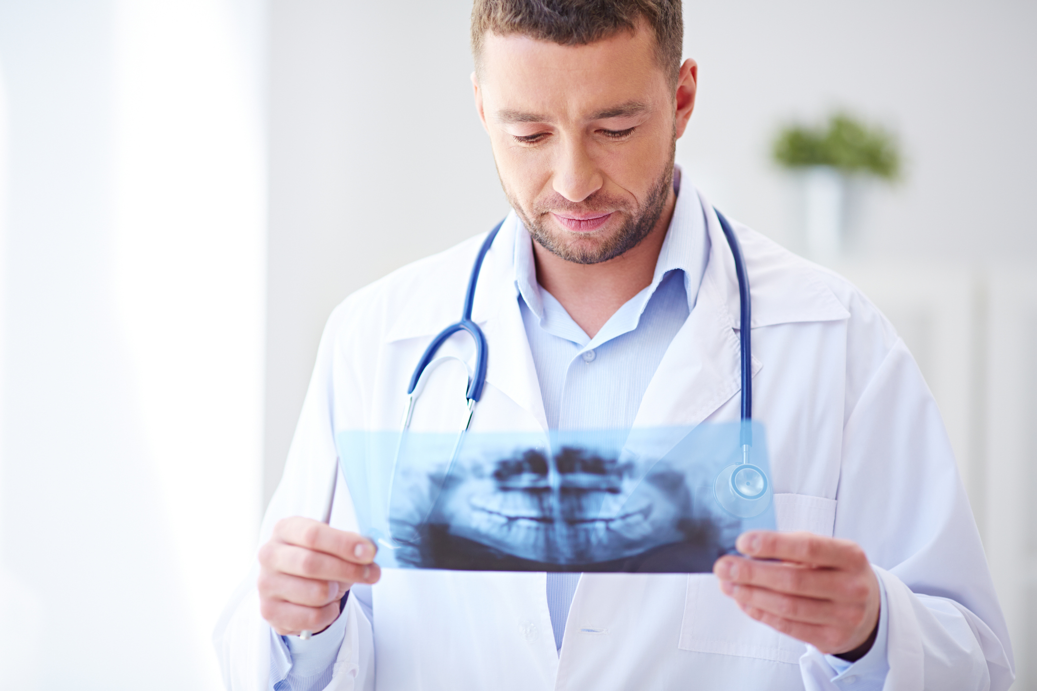 doctor looking at x-ray of mouth