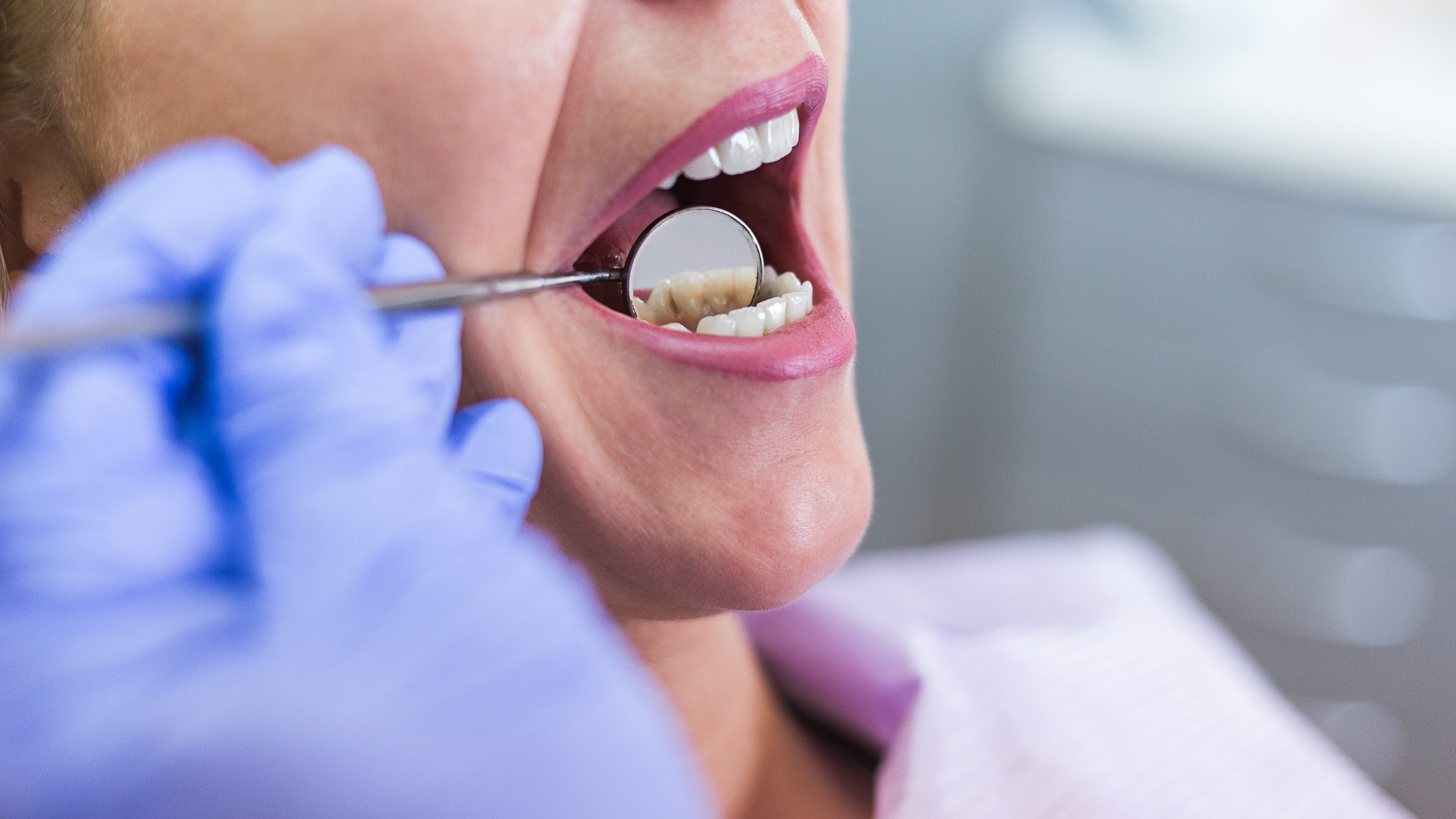 oral surgeon checking teeth